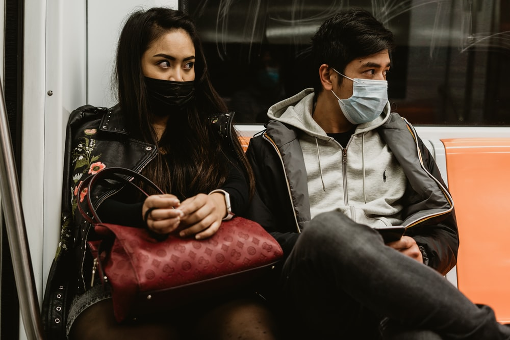 Couple on public transport wearing masks